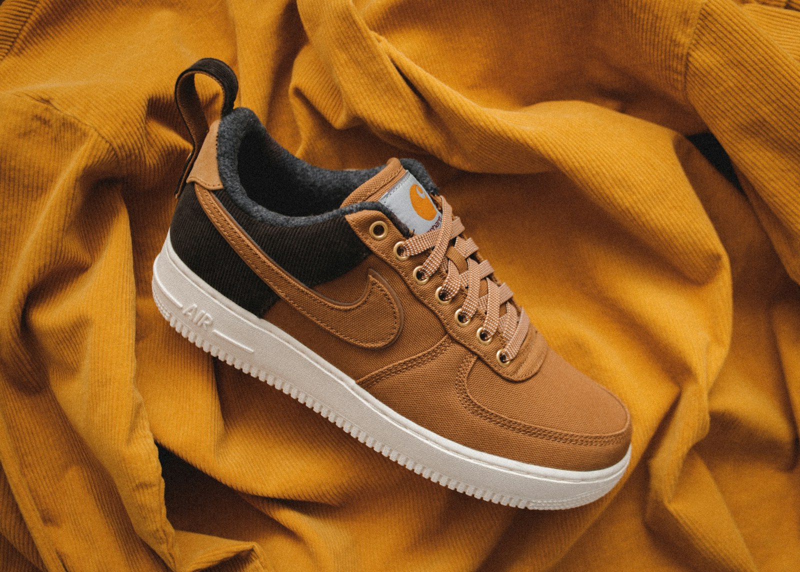 Orange and brown trainers on a plain background