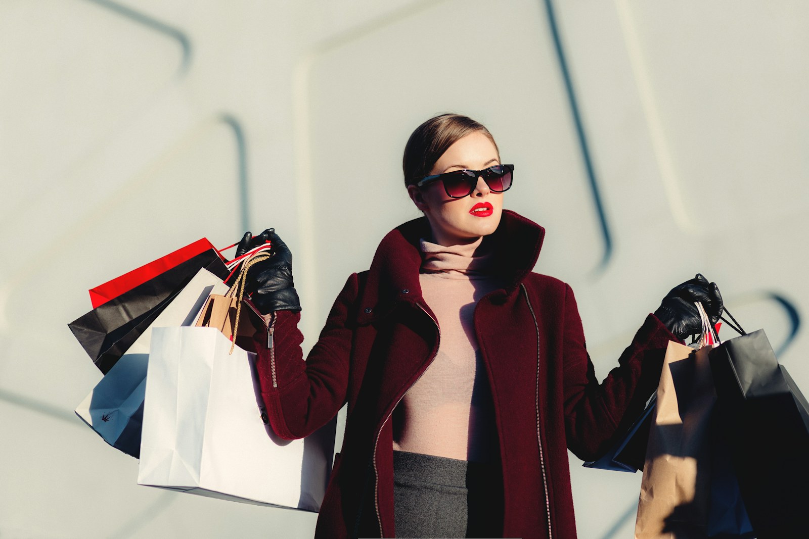 Woman wearing a coat and carrying shopping bags